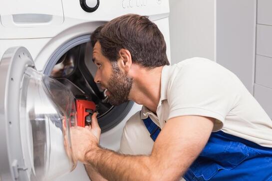 man fixing a washing machine